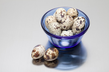Quail eggs in blue bowl.