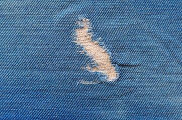 Denim Texture as Background. Denim Background. Patched hole in jeans. Clothing repair concept