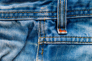 Denim Pants Elements as Background. Detail of jeans trousers close-up. Pockets, pants, belt loops,...