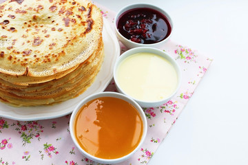 Pancakes with jam, honey and sour cream