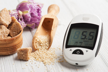 glucose meter, seeds of sesame and brown sugar