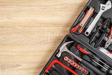 New square black tool box on wooden texture background