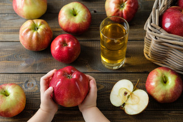 large ripe apple in children's hands