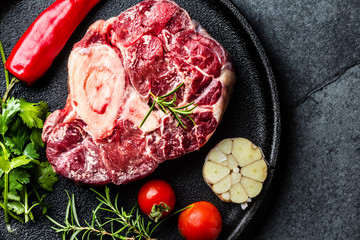 Raw osso buco veal shank on slate background. Top view