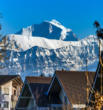 Beautiful snowy mountains, sunny day in Alps