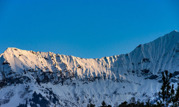 Beautiful snowy mountains, sunny day in Alps