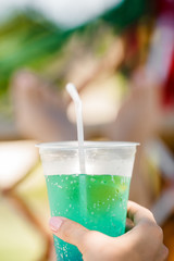  woman holding cocktail in the hammock