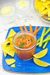 Vegetable dip with tortilla chips celery and carrot sticks
