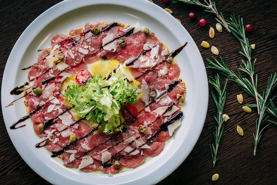 Top view of carpaccio in a white plate