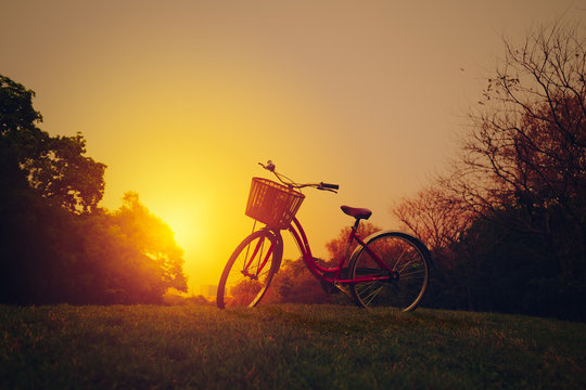 Landscape image of vintage bicycle on beautiful sunset