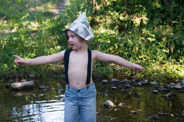 Little boy playing into the creek.