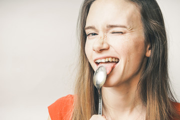 Hungry woman eating spoon