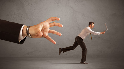 Businessman running from hand