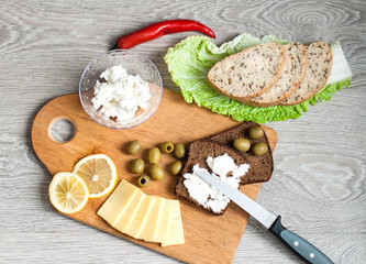 A sandwich with feta cheese for breakfast. Concept for a bakery and healthy food. On a wooden background top view