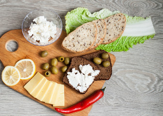 A sandwich with feta cheese for breakfast. The concept of morning and healthy eating. Banner for a cafe, on a wooden background.