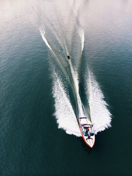 Speed boat towing water skier, high angle view 