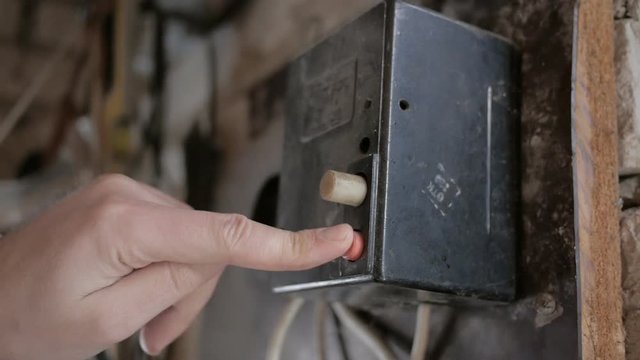Man hands turning switch in a electricity, power shield. Electrical commutation  
