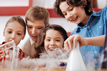 Cheerful nice children visiting a scientific laboratory