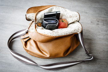 inside woman handbag on the wooden floor
