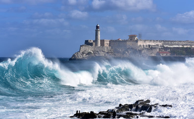 Waves breaking near the Malecon with Morro Castle in the background, Havana, Cuba - obrazy, fototapety, plakaty
