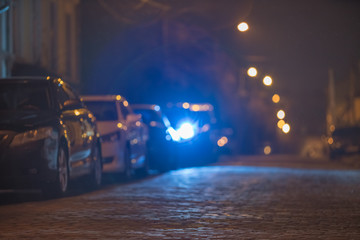 The cars on the stone road. Evening night time. Telephoto lens shot