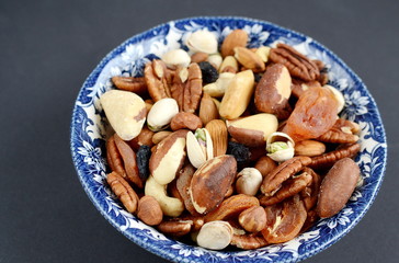 Assorted mixed nuts and dried fruit. Black background