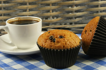 Chocolate muffins with a Cup of coffee on the table