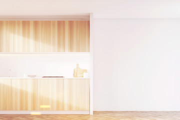 Light wood kitchen with white wall, toned