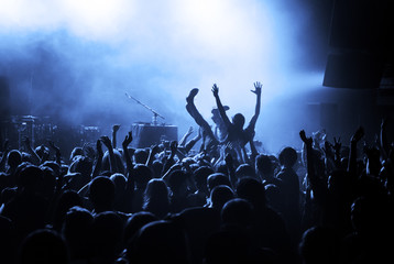 Crowd surfing during a musical performance - obrazy, fototapety, plakaty