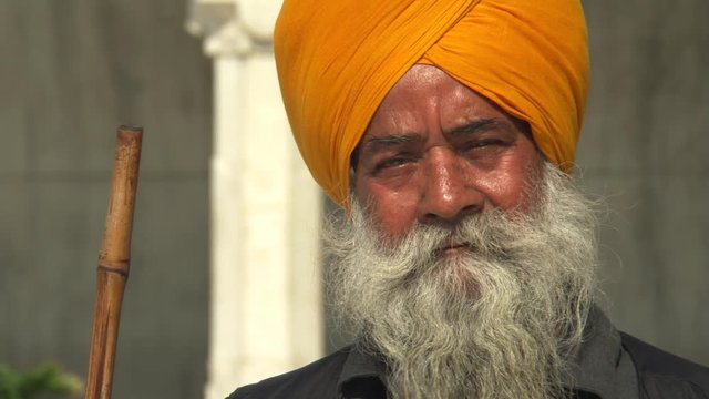 Close-up face of elderly man in yellow turban 