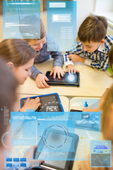 group of school kids with tablet pc in classroom