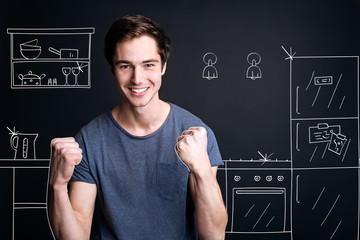 Positive smilign man standing in the kitchen