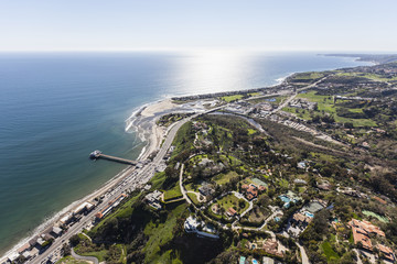 Aerial view of Pacific Ocean view estates and pier in Malibu, California.