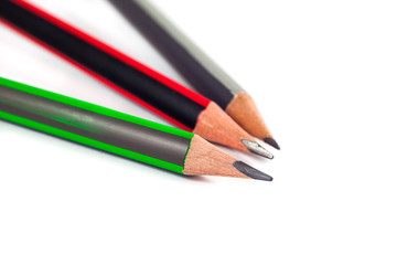 Three pencils on a white background