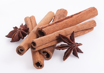 Cinnamon and anise on white background.