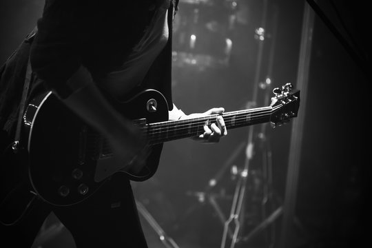 Electric guitar player on stage, monochrome