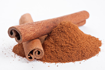 Cinnamon sticks and powder on white background.