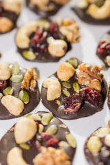 Chocolate cookies with nuts and dried fruits on a white background