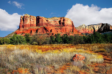 Mountain landscape Sedona Arizona, autumn foliage, iron oxide cliffs, blue skies and billowing...