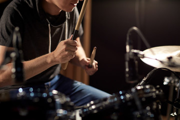 male musician playing drums and cymbals at concert