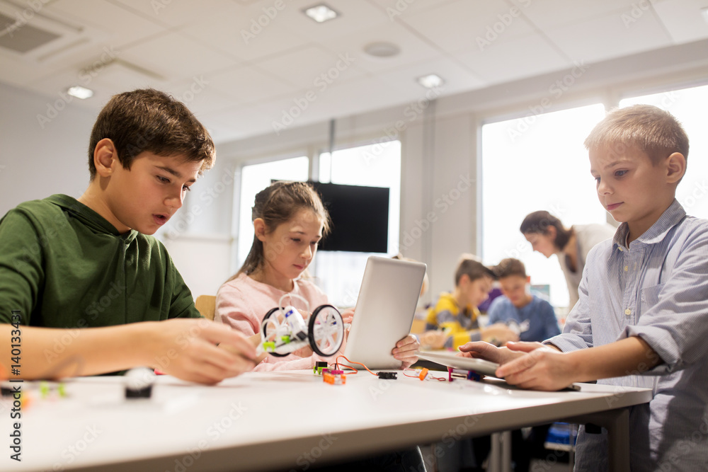 Wall mural kids with tablet pc programming at robotics school