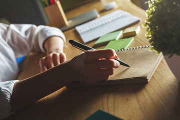 Woman writing in notepad