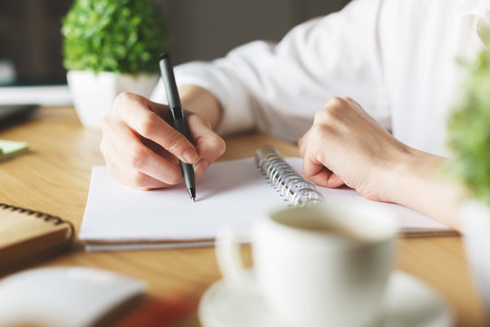 Girl drawing in notepad