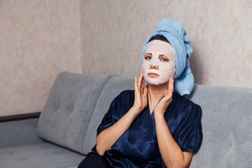 The girl applies and corrects the nourishing mask on the skin. Mask for rejuvenating and...