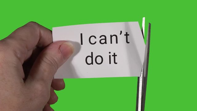 Model holding card in front of green screen, then cutting card multiple times to change text from "I can't do it" to "I can do it".