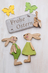 Spring and Easter decor. Wooden symbols bunny, flowers and butterflies.