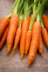 Fresh and sweet carrot on a grey wooden table.