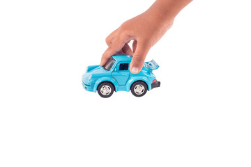 Hand little boy play toy blue car on road  isolate