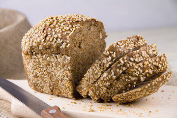 Bread with sesame seeds on a cutting board