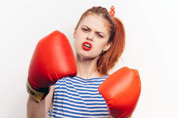 The brunette in boxing gloves on a white background